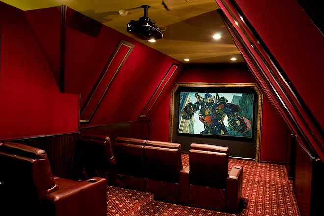 Home theater with a movie playing on screen.